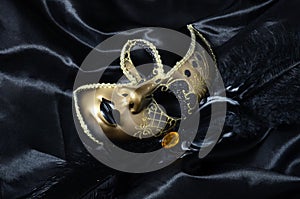 Gold carnival mask with black feathers