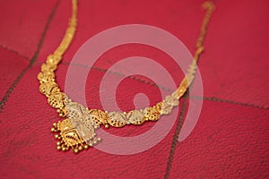 Gold chain on a red background photo