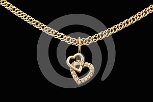 Gold chain and pendant in the shape of heart on a black background