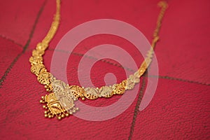 Gold chain on a red background