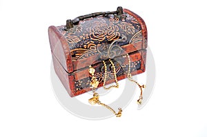 Gold chains in a closed carved wooden treasure box