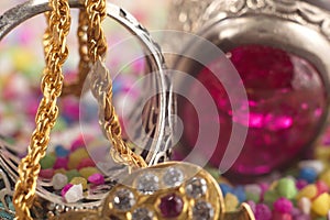 Gold chains diamonds jewellery on colorful pebbles