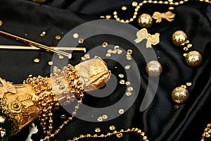 Gold Champagne bottle with confetti stars and party streamers