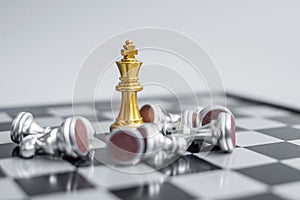 Gold Chess king figure stand out from crowd of enermy or opponent during chessboard competition. Strategy, Success, management,