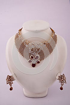 gold choker necklace with rubies and white gems with matching earrings Set on a white backgroun