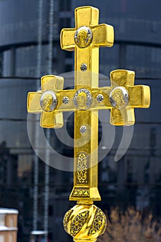 Gold Christian cross on a background of blue sky