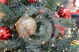 Gold Christmas ball with sparkles and bugles on the Christmas tree