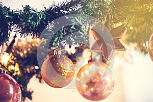 Gold Christmas balls decoration in tree, beautiful sparkles close-up