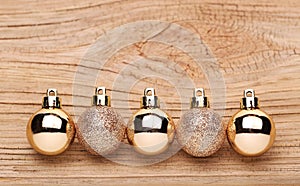 Gold Christmas Balls Over Wooden Background