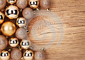 Gold Christmas Balls Over Wooden Background