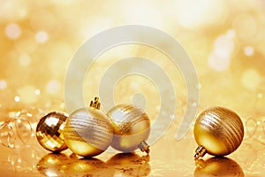 Gold Christmas balls on the shiny background