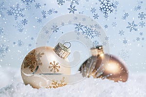 Gold Christmas balls with snow flakes background