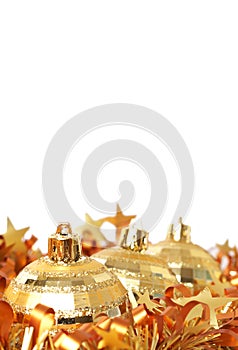 Gold Christmas baubles in tinsel