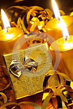 Gold christmas candles and gold gift boxes