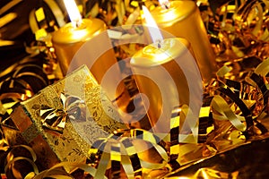 Gold christmas candles and gold gift boxes