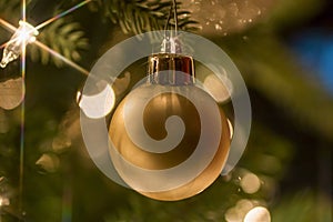Gold Christmas Ornament Hanging on Tree