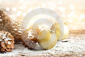 Gold christmas ornament pine cones on wooden