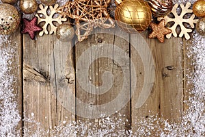 Gold Christmas ornament top border with snow frame on wood