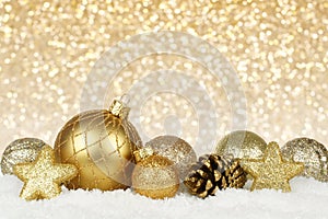 Gold Christmas ornaments with twinkling background