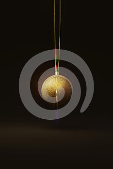 Gold Christmas tree bauble isolated on a dark background. 3d render