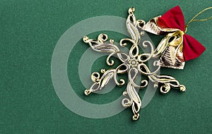 Gold Christmas tree decorations in gold forming an abstract bauble ornament on green background. Traditional symbols for the