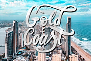 Gold Coast spray paint lettering over aerial photograph of Gold Coast city at sunset in Queensland, Australia.