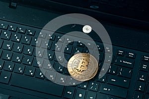 Gold coin Bitcoin on a black keyboard. The concept of crypto currency. Blockchain technology