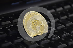 gold coin bitcoin on computer keyboard