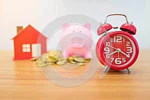 Gold coin,small house , piggybank and alarm clock