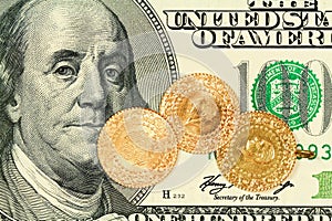 Gold coins on 100 Dollar