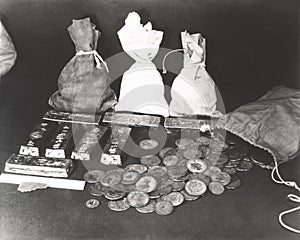 Gold coins and bars laid out on table