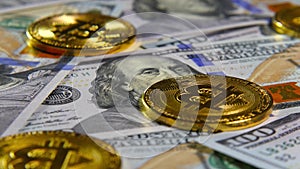 Gold coins of bitcoins and a background of hundred-dollar bills. The concept of financial operations. Economy of the