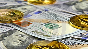 Gold coins of bitcoins and a background of hundred-dollar bills. The concept of financial operations. Economy of the