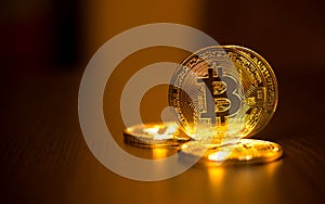 Gold coins of bitcoins on an office table on a dark background