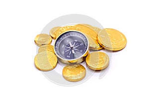 Gold coins and compass, business and travel concept.