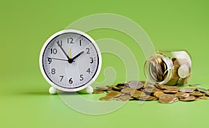 gold coins in glass jars on green background, coin savings concept