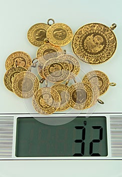 Gold coins on a jewelery scale