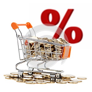 Gold coins in shopping cart with sign of sale on background