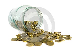 Gold coins spilling from a jar