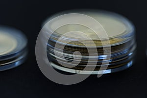 Gold coins stack on the black background