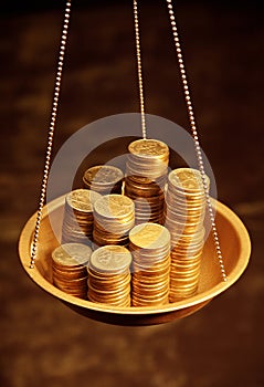 Gold coins on weighing scales