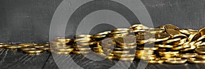 Gold coins on a wooden table banner. Money on a black background.Copy space. Treasure Hunt.Chalk rubbed out on