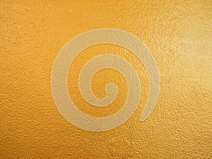 Gold color background. Rough gold texture design on the wall