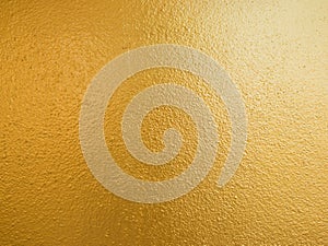 Gold color background. Rough gold texture design on the wall