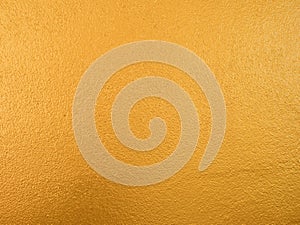 Gold color background. Rough gold texture design on the wall