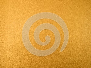 Gold color background. Rough gold texture design on the wall