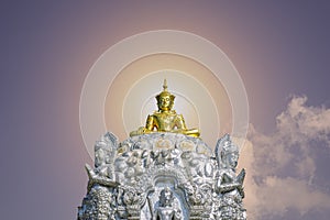 Gold color Buddha image on silver pedestal with an angel statue around