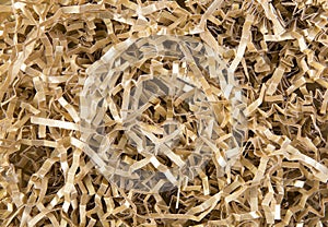 Gold color shredded paper - gift box filler background.