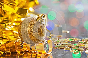 Gold colored christmas ball with string on background of bokeh h