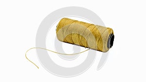 front view of a spool of gold embroidery thread isolated on white background. made from polyester